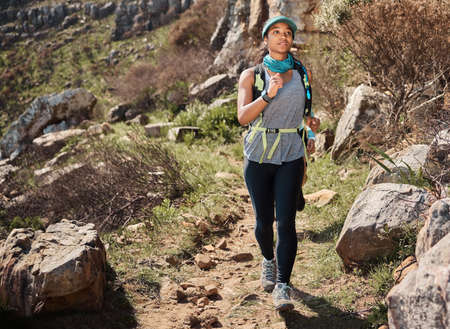 I will prove to myself that I can do this. a young woman running along a trail on the mountain.