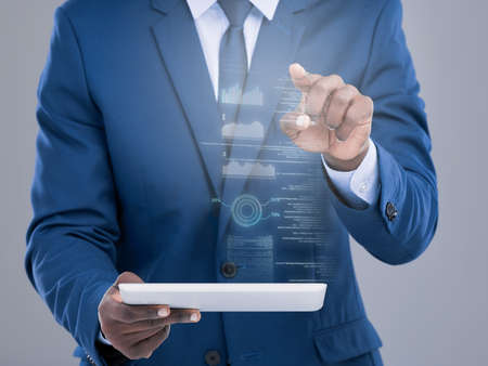 The world at your fingertips. an unrecognizable businessman using his tablet to open a virtual...
