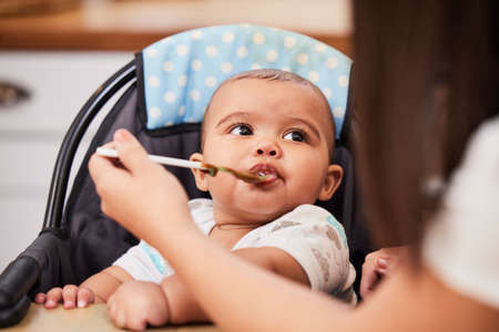 Its delicious, did you make it. a mother feeding her adorable baby boy.