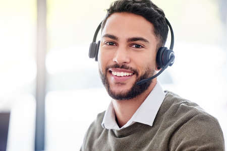 Im the agent you need. Cropped portrait of a handsome young male call center agent working in his...