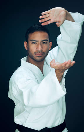 Its all about technique. Cropped portrait of a handsome young male martial artist practicing karate...