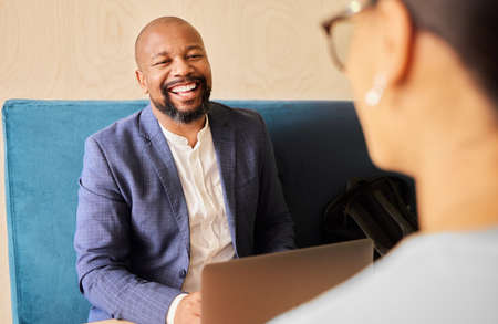 A mentor and leader. a handsome mature businessman meeting with a female colleague in the office.