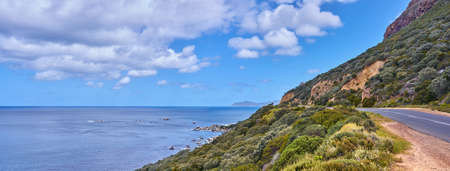 Copy space with sea view and a street along the mountain against a cloudy sky background at the...