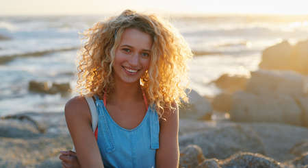 portrait attractive blonde woman on beach at sunset smiling enjoying summer travel lifestyle on...