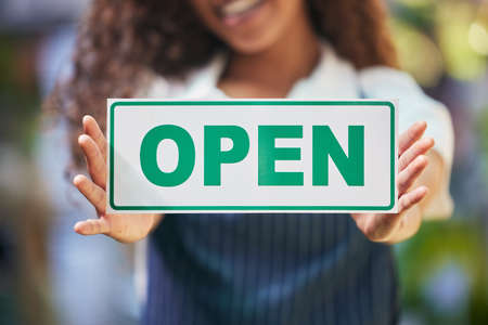 Were ready for business. a business owner holding an open sign.