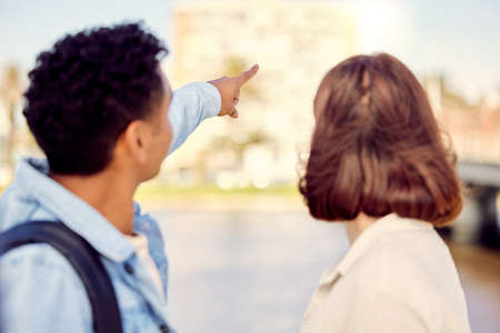 Lets get a little closer. a young couple exploring a city together.の写真素材