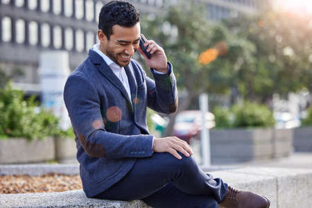 Well get on it tomorrow. a businessman using his smartphone to make a phone call.の写真素材