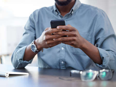 Success only comes before work in the dictionary. a unrecognizable male using a phone at work in a...