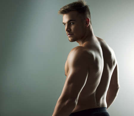Hes a knockout. Studio portrait of a muscular young man posing against a grey background.