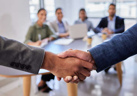 Welcome to the team. two business people shaking hands in greeting.