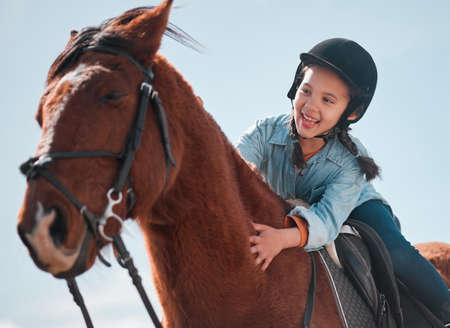 Theres no better adventure than riding a horse. an adorable little girl riding a horse.の写真素材