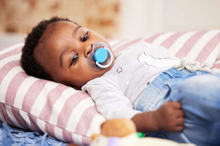 Being this cute gets tiring. a little baby girl lying down for a nap.