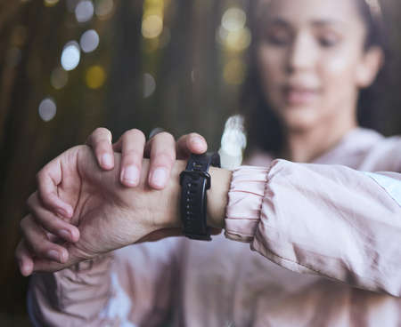 Any progress is good progress. a sporty young woman checking her watch.の写真素材