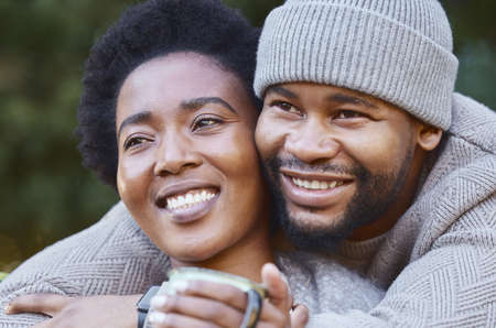 a young couple hugging during a camping trip.