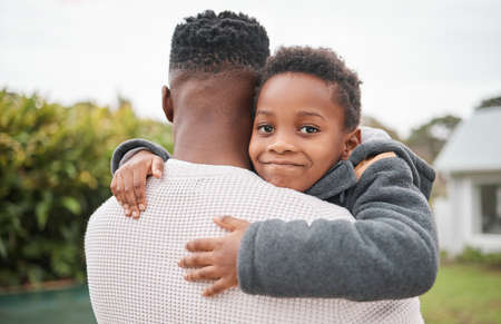 Daddy is my hero. Portrait of an adorable little boy being carried by his father while bonding...
