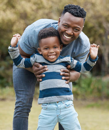 Im so proud of my little boy. a young father bonding with his son while playing outside in the garden.の写真素材