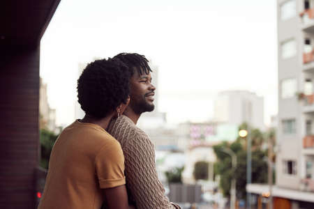 Love is what makes life so sweet. an affectionate your couple bonding on a balcony outdoors.の写真素材