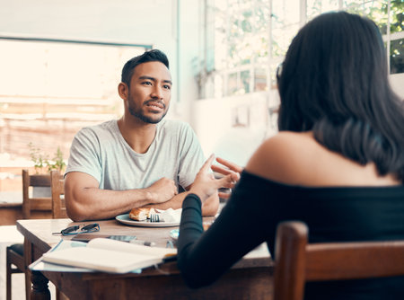 Couple, dating and cafe date while serious boyfriend and girlfriend with good communication over lunch. Man and woman talking about business proposal and listening to ambition in relationshipの写真素材