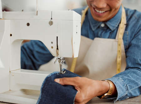 Design student, creative and worker in a studio sewing clothes and garments. Fashion student...