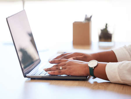 Businesswoman, manager or advertising agent typing a report, email or browsing the internet on a...