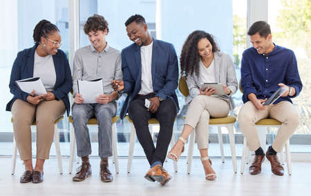 Staying well-prepared for anything that comes their way. a group of businesspeople sitting in line...