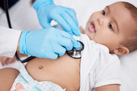 It is a smile of a baby that makes life worth living. a little baby having its chest checked by a...