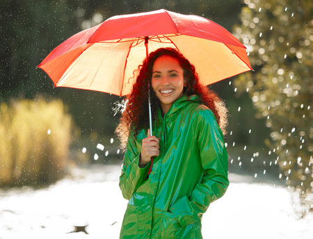 A relaxing walk in the rain does wonders for the soul. a beautiful young woman spending a day...