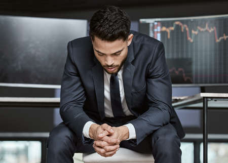 Businessman with depression on the stock market, trading during a financial crisis. Stressed trader...
