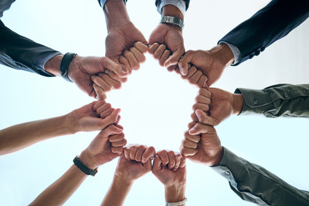 We can achieve anything together. Below shot of a group of unrecognizable businesspeople joining their hands together in a unity.の写真素材