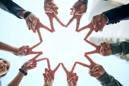 Never forget that youre a star. a group of unrecognizable businesspeople making a star shape with their hands.の写真素材