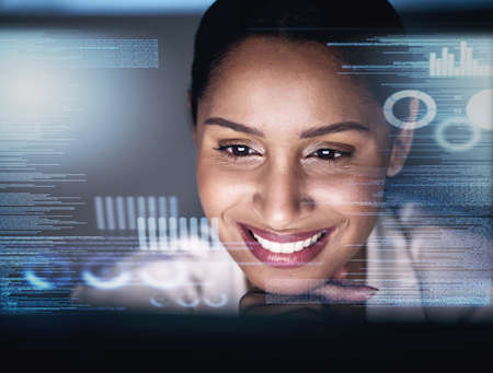It seems the business chose to grow this evening. an attractive young businesswoman sitting alone in her office at night and using her computer.の写真素材