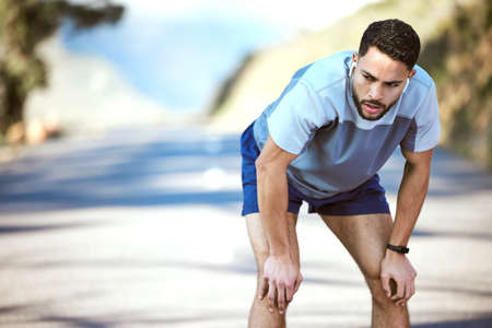 The hard days are what make you stronger. a sporty young man catching his breath while exercising...