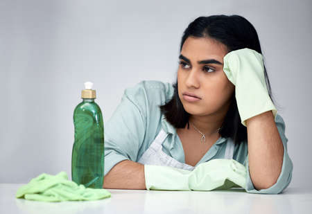 I cant believe they sent the wrong products. a young woman looking angry while cleaning.