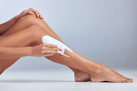 This is the best shaving cream on the market. an unrecognizable woman sitting alone and shaving her...