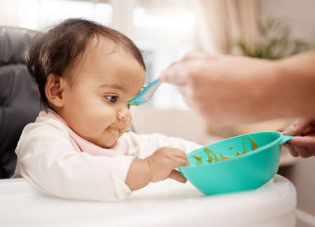 I hope youre going to refill this. an adorable baby girl eating her food.の写真素材