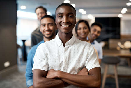 Fiercely determined all the way to the finish line. Portrait of a group of confident young businesspeople working together in a modern office.の写真素材