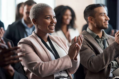 See the future. a group of young businesspeople clapping during a conference in a modern office.