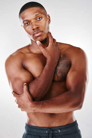 Dont misconstrue and dont misapprehend. Studio portrait of a shirtless handsome young man posing against a white background.の写真素材