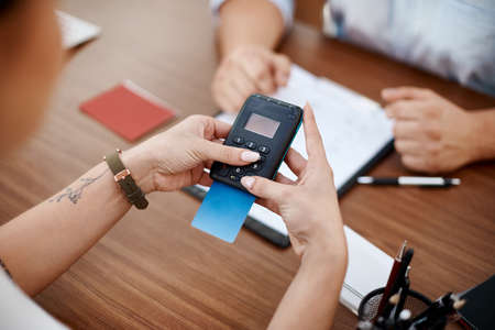 Lets spend the big bucks. a customer paying for their new car using their bank card.の写真素材