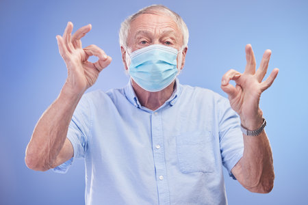 Compose a life of longevity. Studio shot of a senior man wearing a face mask against a blue background.の写真素材