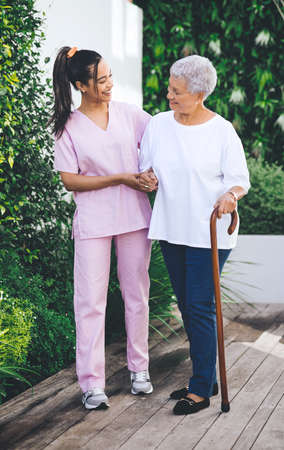 Forever in debt to your priceless advice. an older woman using a walking stick and walking with the...