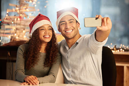 Making memories through all the holidays. two young businesspeople taking a selfie while celebrating...
