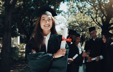 I dont know where Im going, but Im on my way. a student holding her diploma on graduation day.の写真素材