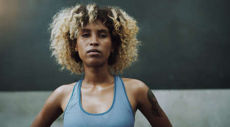 Who are you calling average. Portrait of a sporty young woman standing in a gym.の写真素材