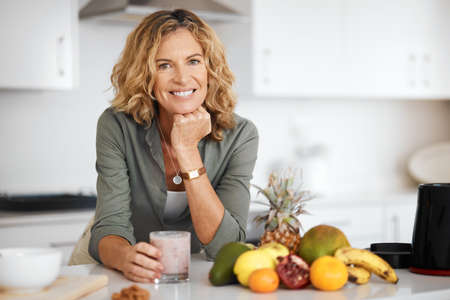 My life has never been better. a woman about to drink a glass of smoothie.の写真素材