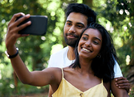 Its our first selfie together. a young couple taking a selfie while out on a date.の写真素材