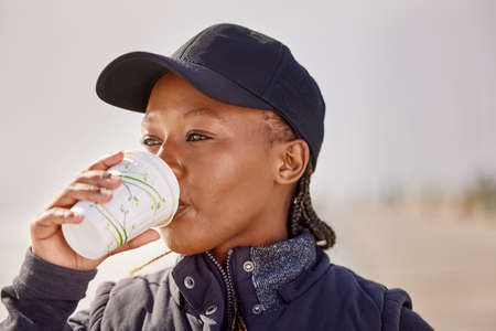 A cup of coffee can do wonders for your day. a young woman enjoying a cup of coffee.の写真素材
