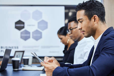 Ready to take some digital notes. a young businessman using a digital tablet during a meeting in an...