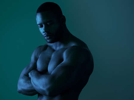 My muscles are my best clothes. a handsome young man posing topless in studio.の写真素材