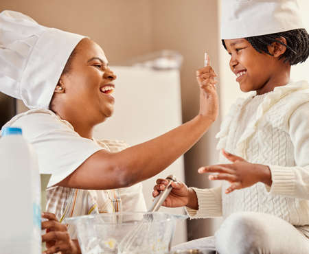Love is the secret ingredient to our family recipe. a mother and her daughter baking in the kitchen...